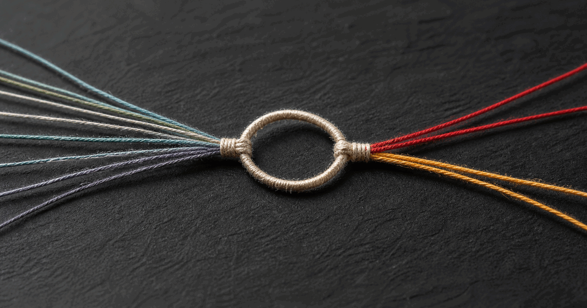 Colored threads tied into one loop with red and amber strands preserved