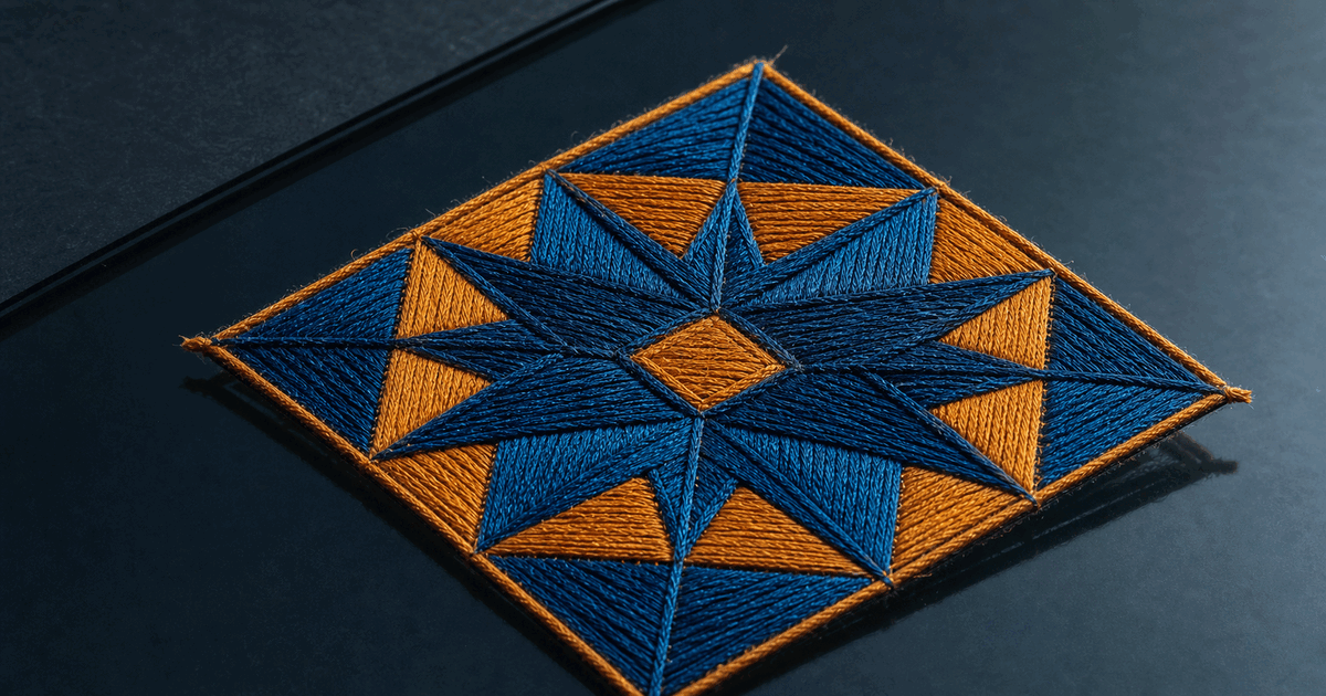 Blue and amber embroidery stitched across a dark glass surface